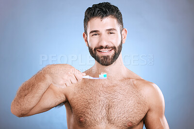 Buy stock photo Teeth, toothbrush and portrait of man in studio for dental wellness, healthy smile and mouth care. Happy face, male model and oral cleaning for fresh breath, gums and dentistry on blue background 
