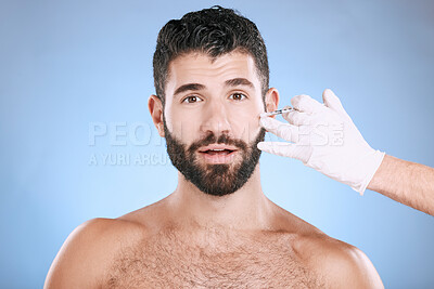 Needle, man and portrait for skincare, collagen and beauty process in studio. Cosmetics, surprise face and injection for plastic surgery of botox, facial change and aesthetic prp on blue background