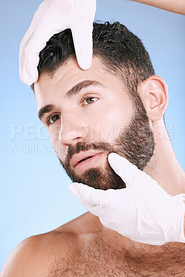 Buy stock photo Face, plastic surgery and hands check man for laser, botox implant or beauty clinic. Skincare consultation, facial and gloves of aesthetic change, male cosmetics filler or body prp on blue background