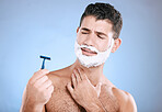 Shaving, beard and confused man with razor in hand, foam product placement in studio mock up. Shave  accident, cream on face and hair or skincare for male model grooming, isolated on blue background.
