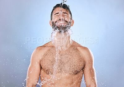 Buy stock photo Man, water splash and skin care or shower with clean face for beauty, hygiene and dermatology. Aesthetic model person on blue background for health and wellness cosmetics, body and detox cleaning