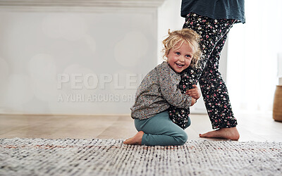 Buy stock photo Happy, child clinging to leg of woman and playful fun and smile on carpet in home with mother. Little girl playing, laughing and joking with happiness, mom in pajamas and trust on floor in apartment.