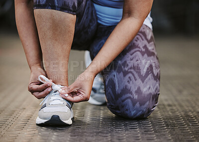 Buy stock photo Hands, tie shoes and fitness in gym to start workout, training or exercise for wellness. Sports, athlete and woman tying sneakers or footwear laces to get ready for exercising or running for health.