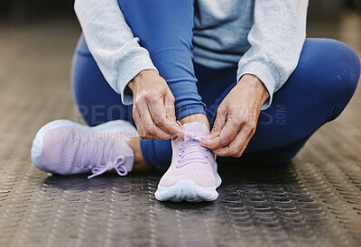Buy stock photo Hands, fitness and tie shoes in gym to start workout, training or exercise for wellness. Sports, athlete health or senior woman tying sneakers or footwear laces to get ready for exercising or running