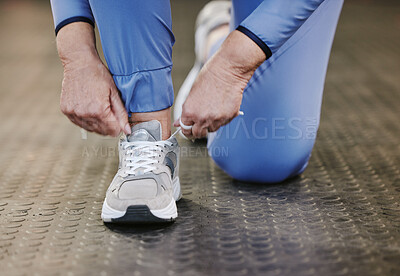 Buy stock photo Hands, sports and tie shoes in gym to start workout, training or exercise for wellness. Fitness, athlete health or senior woman tying sneakers or footwear laces to get ready for exercising or running