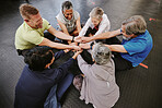 Top view, exercise and senior group holding hands, training goal and celebration for teamwork. Old men and elderly women huddle on floor, touching and connect for achievement, stretch arms or fitness