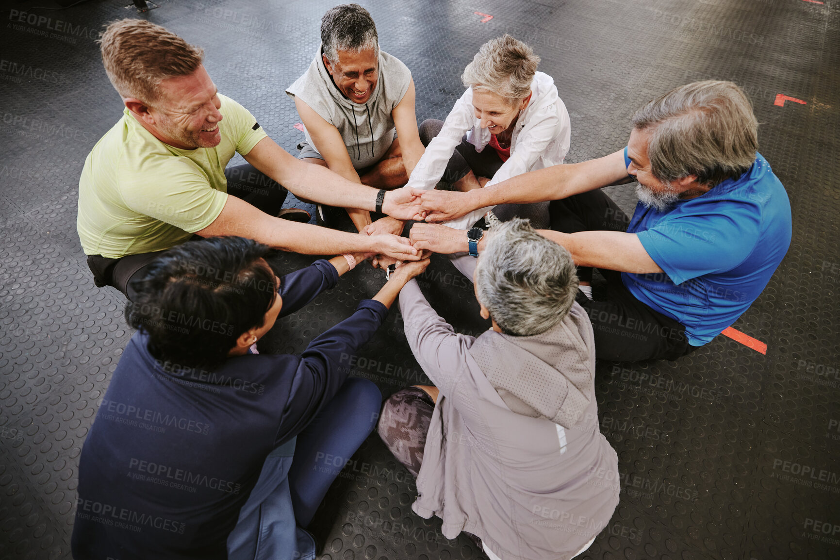 Buy stock photo Top view, exercise and senior group holding hands, training goal and celebration for teamwork. Old men and elderly women huddle on floor, touching and connect for achievement, stretch arms or fitness
