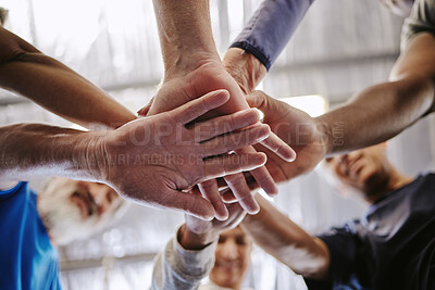 Buy stock photo Teamwork, hands together and low angle of people in gym for motivation, solidarity and team building. Collaboration exercise, group of friends or retired senior men and women huddle for workout goals