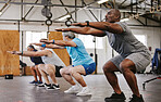People, fitness and stretching in class at gym for workout, squat exercise or training together. Diverse group or team in warm up stretch session for sports, health and cardio wellness at gymnasium