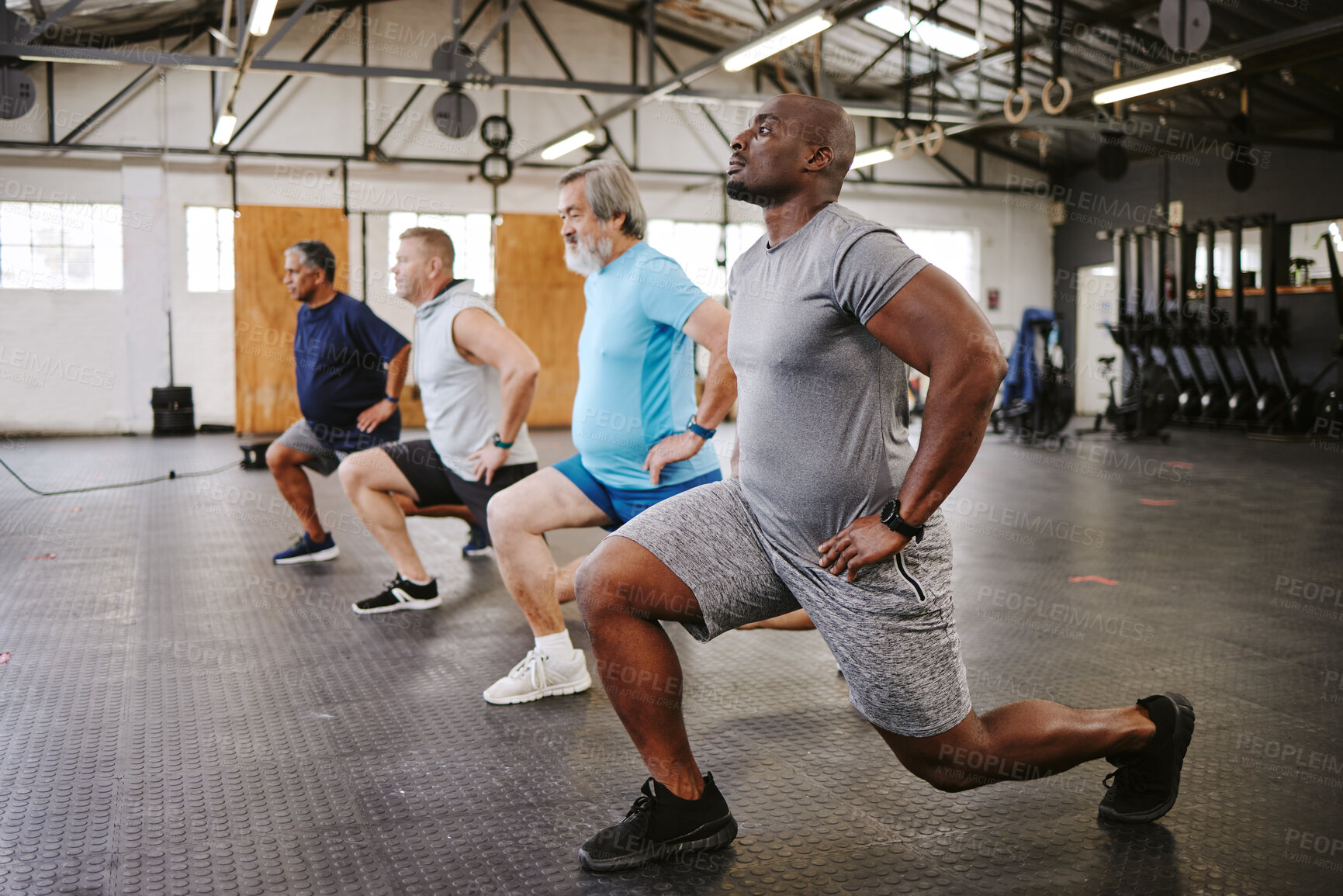 Buy stock photo People, fitness and stretching legs in class with personal trainer at gym for workout, exercise or training. Diverse group in warm up leg lunge session with coach for cardio wellness on floor