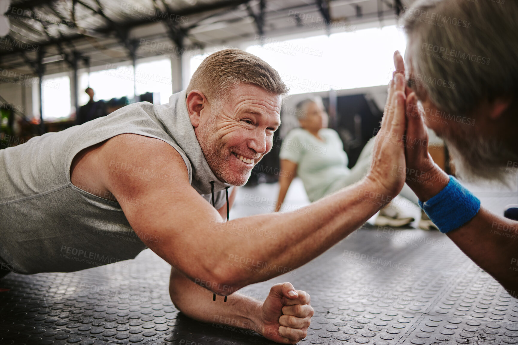 Buy stock photo Exercise, old men on floor and high five for achievement, fitness goals or happiness in gym. Mature male athletes, senior citizens or gesture for celebration, workout target or on ground for training