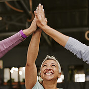 Fitness, teamwork and high five of senior women in gym celebrating workout  goals. Sports targets, laughing face and group of happy friends with hands  together for success and exercise achievements.