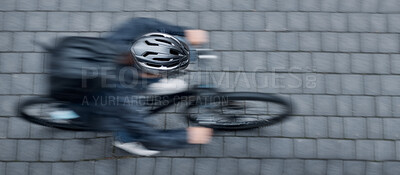 Buy stock photo Bike, motion blur and overhead with a person cycling on a brick road at speed to commute in the city. Bicycle, travel and fast with a cyclist sitting whileriding on eco friendly wheels for traveling