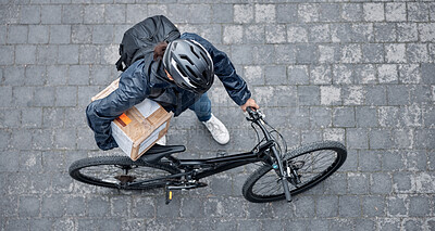 Delivery, package and man with a bicycle and box in the street for consumer order in the city. Transport, courier and male bike driver with stock with eco friendly transportation in the road in town.
