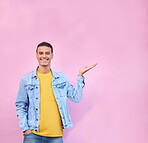 Happy, mockup and portrait of a man in a studio pointing to empty space for advertisement or marketing. Happiness, smile and male model showing mock up or copyspace isolated by a pink background.