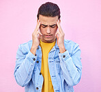 Depression, stress and man with headache in studio isolated on a pink background. Mental health, anxiety and  depressed, unhappy or sad male model with problem, pain or migraine, burnout or head ache