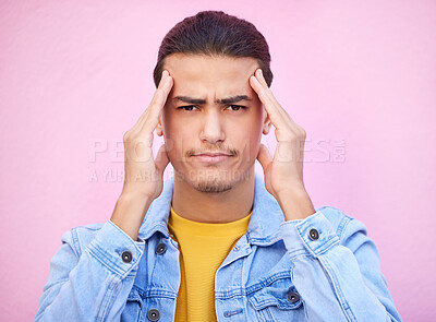 Buy stock photo Portrait, stress and man with headache in studio isolated on a pink background. Mental health, anxiety and face of depressed and sad male model with depression, pain or migraine, burnout or head ache