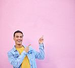 Man pointing, wall mockup space and smile for portrait with fashion, happy and excited face by backdrop. Gen z model, gesture and hands with happiness, mock up and student by urban pink background