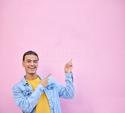 Buy stock photo Man pointing, wall mockup space and smile for portrait with fashion, happy and excited face by backdrop. Gen z model, gesture and hands with happiness, mock up and student by urban pink background