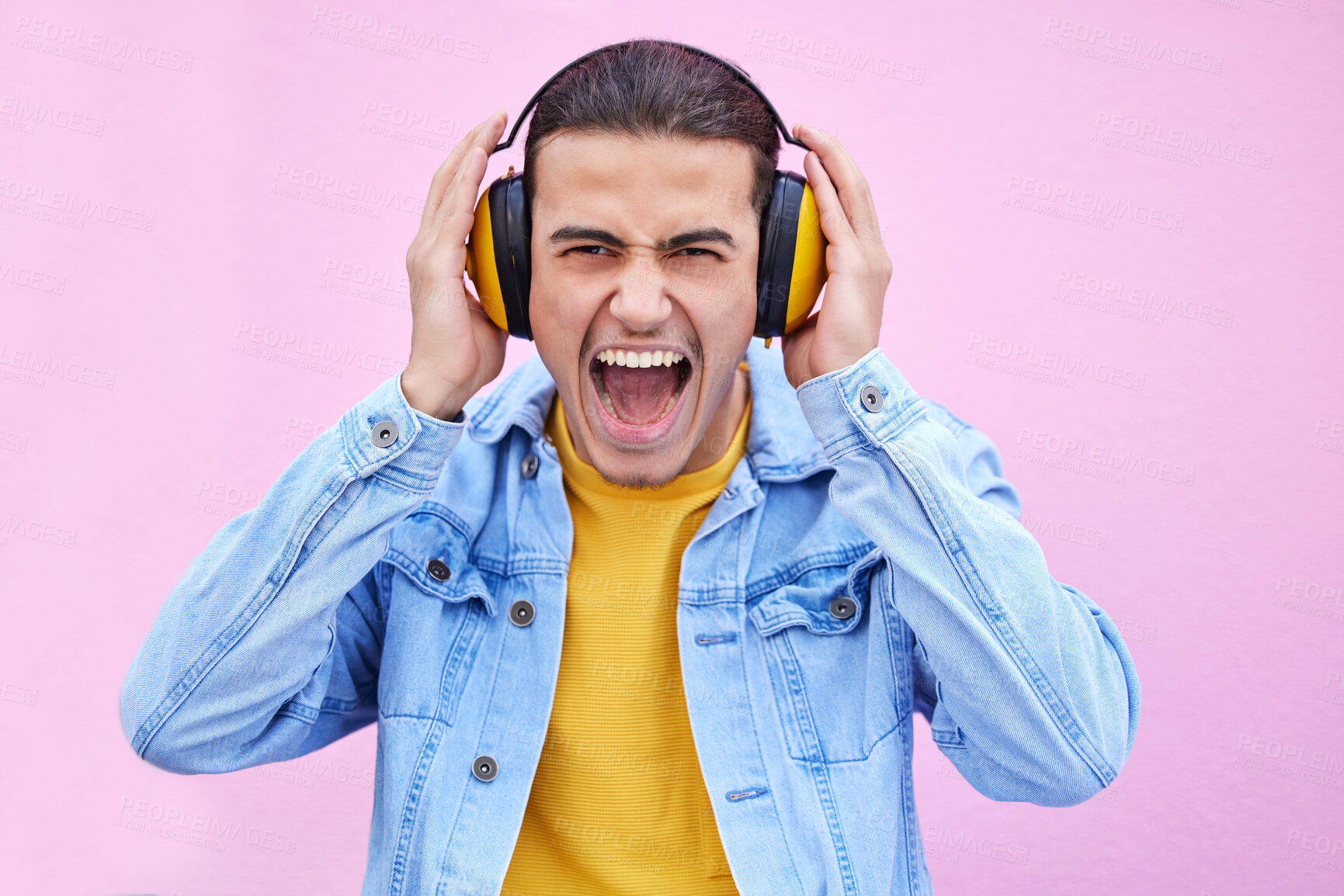 Buy stock photo Headphones, man and screaming portrait on background, pink wall backdrop or studio mockup. Crazy guy listening to music, shouting and loud volume for streaming media with sound, audio hearing or face