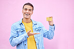 Happy, portrait and man with a bank card in a studio with a positive, optimistic and proud mindset. Happiness, smile and face of a male model with a gold credit card isolated by a pink background.