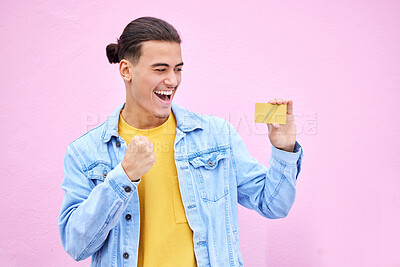 Buy stock photo Happy, celebrate and man with a credit card in studio with success, excitement and celebration. Happiness, excited and male winner doing ecommerce shopping with gold bank account by a pink background