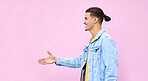 Hand shake, smile and welcome with man and wall background with mockup for greeting, agreement or thank you. Deal, hello and approve with profile of guy and pink background for positive gesture