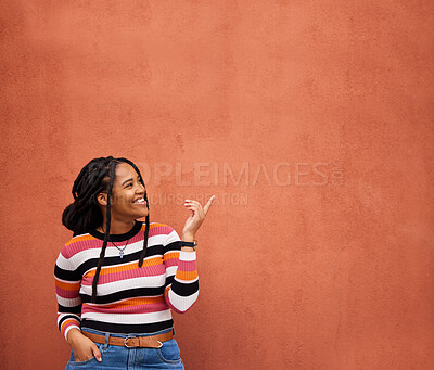 Buy stock photo Mockup, pointing or black woman with marketing, product placement or branding space on wall background. Smile or African gen z girl advertising discount deal, sales offer or promotion announcement