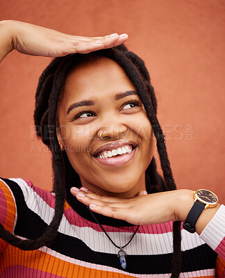 Buy stock photo Pose, happy and woman thinking with hands isolated on a brown studio background. Idea, frame and young girl smiling with happiness, thoughtful and playful while posing on a backdrop for fashion