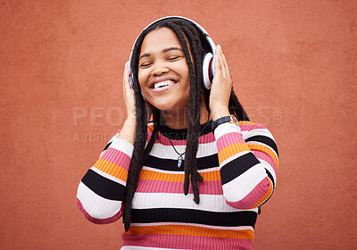 Buy stock photo Wall, black woman and headphones for happiness, radio and freedom with girl chilling, calm and relax on studio backdrop. Jamaican, happy female and lady with headset for music, streaming and podcast