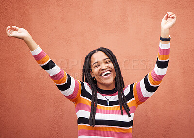 Buy stock photo Celebration, energy and woman by a wall in the city on a walk while on a holiday or weekend trip. Happiness, smile and African female celebrating with freedom in urban town on a vacation or adventure