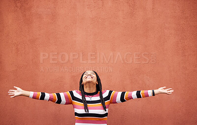 Buy stock photo Black woman, open arms and wall background with space for mock up with smile, happiness and excited in city. Young gen z girl, outdoor and happy with mockup, fashion and palm with product placement