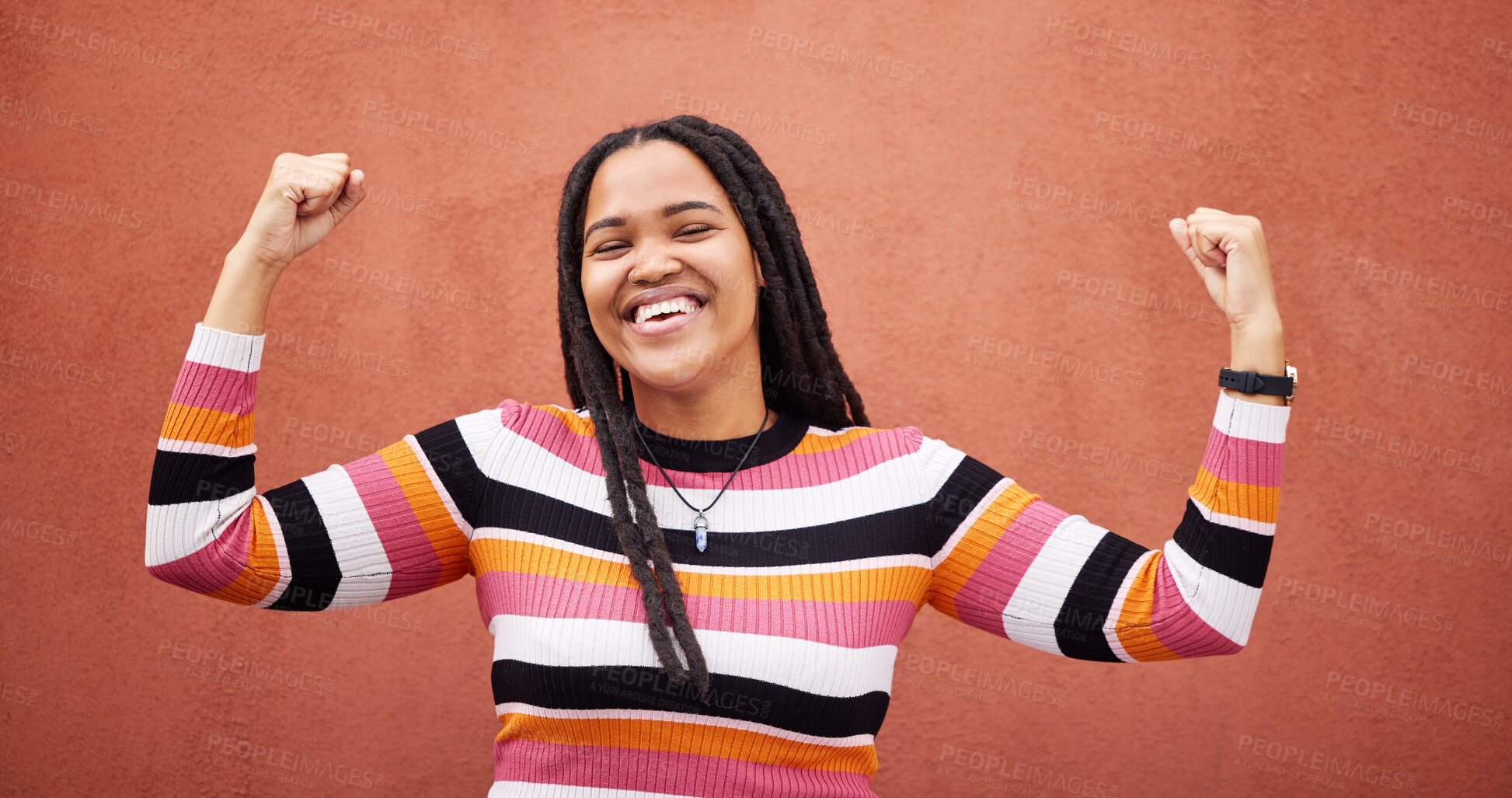 Buy stock photo Celebration, happy and woman by a wall in the city on a walk while on a holiday or weekend trip. Happiness, smile and African female celebrating with freedom in urban town on a vacation or adventure.