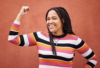 Buy stock photo Flexing, smile and portrait of a strong black woman for empowerment isolated in studio brown background. Confident, excited and young fashion, style and female model proud to be African American