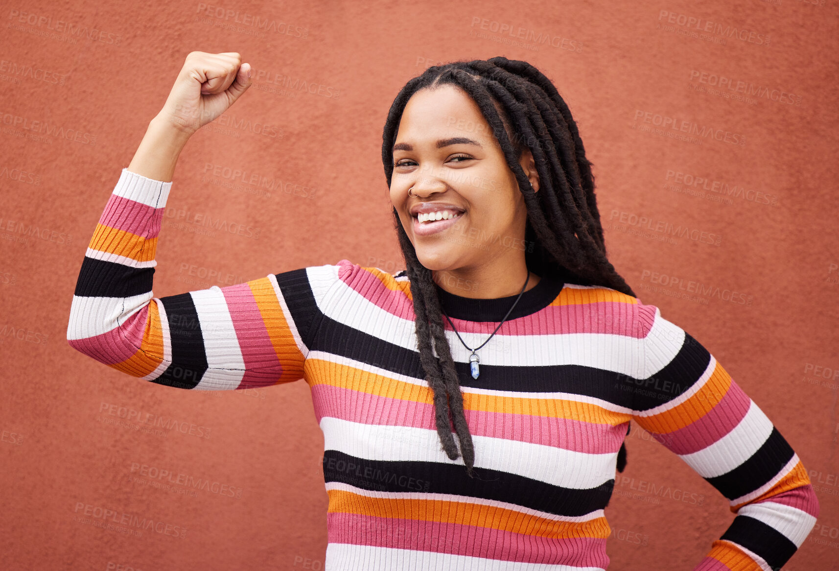 Buy stock photo Flexing, smile and portrait of a strong black woman for empowerment isolated in studio brown background. Confident, excited and young fashion, style and female model proud to be African American