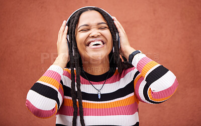 Buy stock photo Black woman, music headphones and happy by wall in city for walk, adventure and me time with smile. Young gen z girl, audio streaming and excited listening on radio, website and happiness in metro