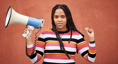 Buy stock photo Protest, megaphone and portrait of a woman by a wall in the city for freedom, equality and human rights. Fist, speaker and African female fighting at a rally for justice, democracy and racism in town