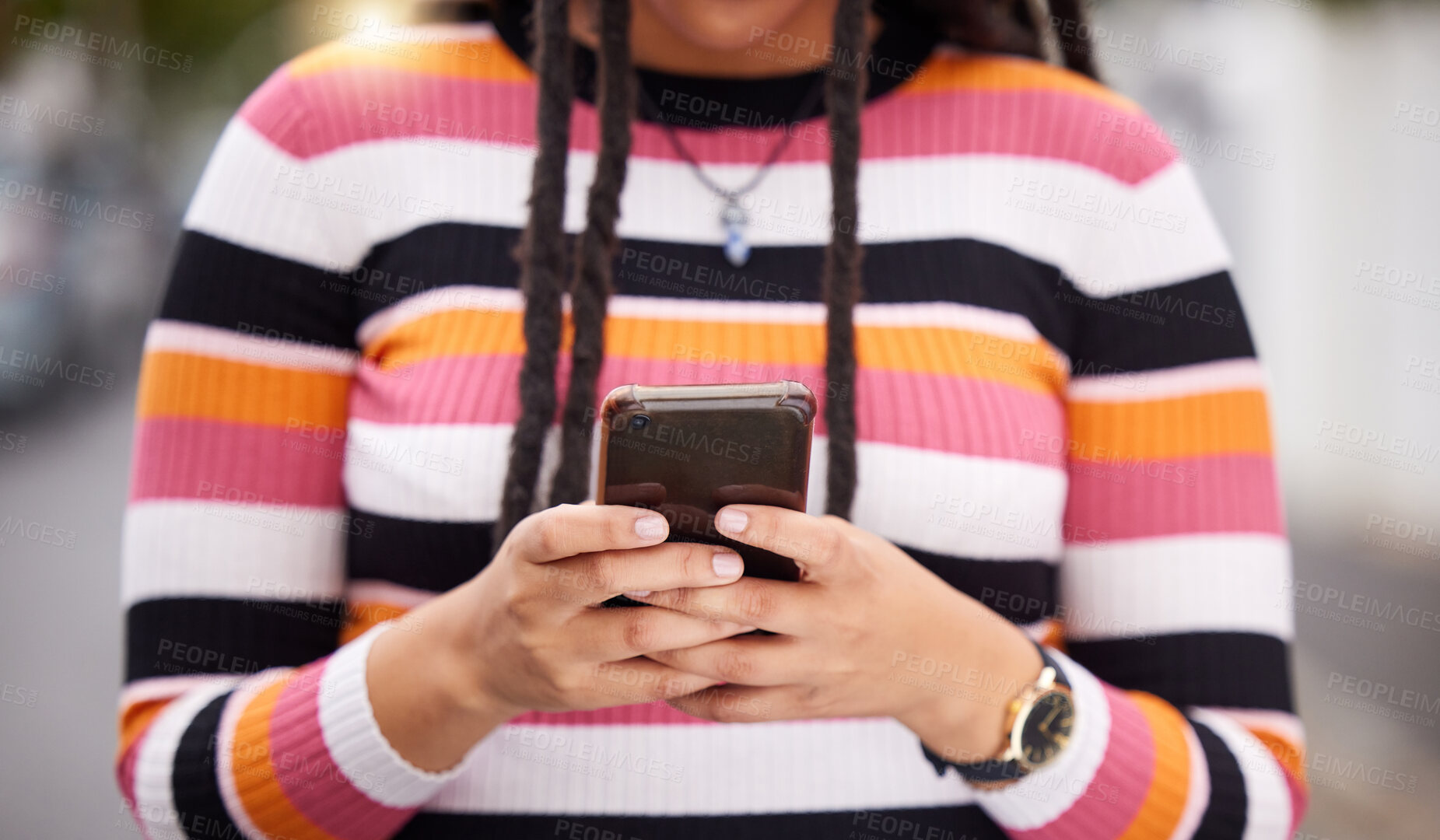 Buy stock photo Closeup, hands and black woman with smartphone, city and typing for social media, connection and online reading for email. Zoom, female and African lady with cellphone, carefree and freedom in street