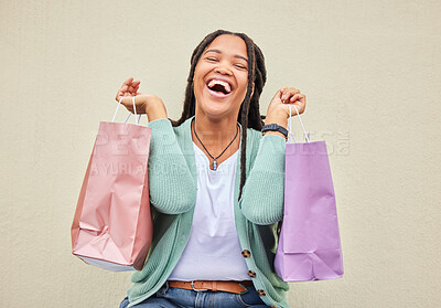 Buy stock photo Fashion, funny or happy black woman with shopping bag, gift or smile in retail therapy with wall mockup. Freedom, relax or excited customer laughing with clothes or products on discounted sales offer