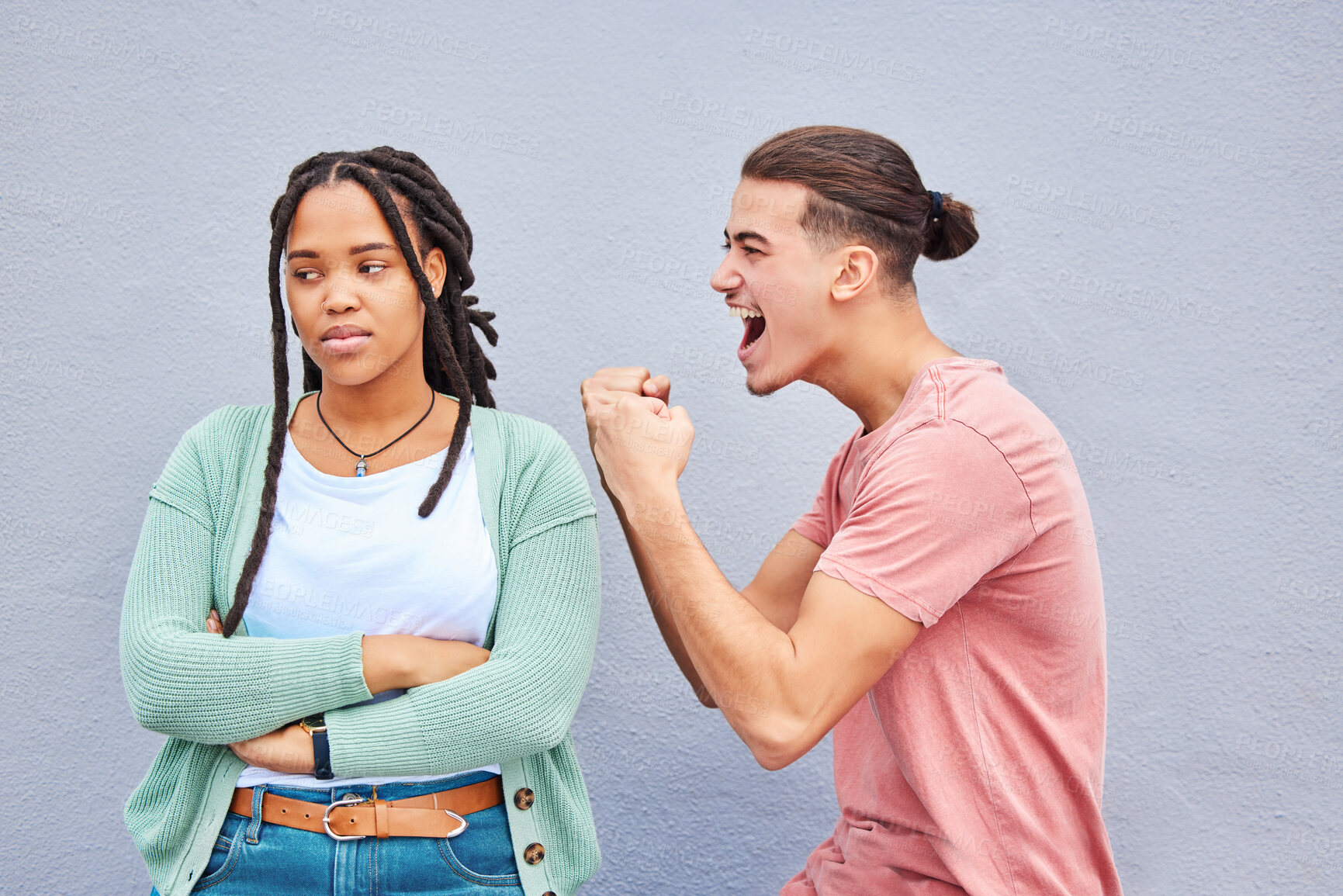 Buy stock photo Winner, competition and success with a man celebrating after winning a bet against his loser girlfriend on gray background. Success, wow or victory with a boyfriend cheering a win against a woman