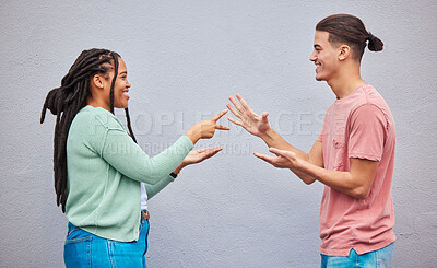 Buy stock photo Couple playing rock, paper, scissors by a wall in the city for game, decision or choice while on holiday. Playful, happy and interracial and woman having fun together in town while on a vacation.