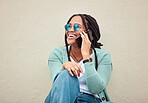 Black woman, phone call and sunglasses by wall in city, happy and smile with fashion in summer. Young gen z, african student girl or smartphone for travel, urban adventure or aesthetic with happiness