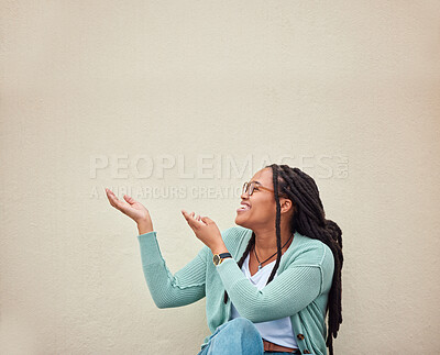 Buy stock photo Happy, black woman and hands pointing to mockup, advertising or empty background, laugh and excited. Hand gesture, smile and girl relax in studio while showing wall copy space for isolated marketing