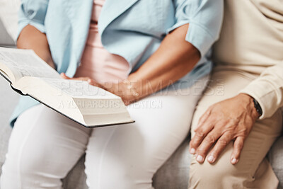 Buy stock photo Hands, bible and praying with a senior couple reading a book together in their home during retirement. Jesus, faith or belief with a man and woman in prayer to god in a house for spiritual bonding