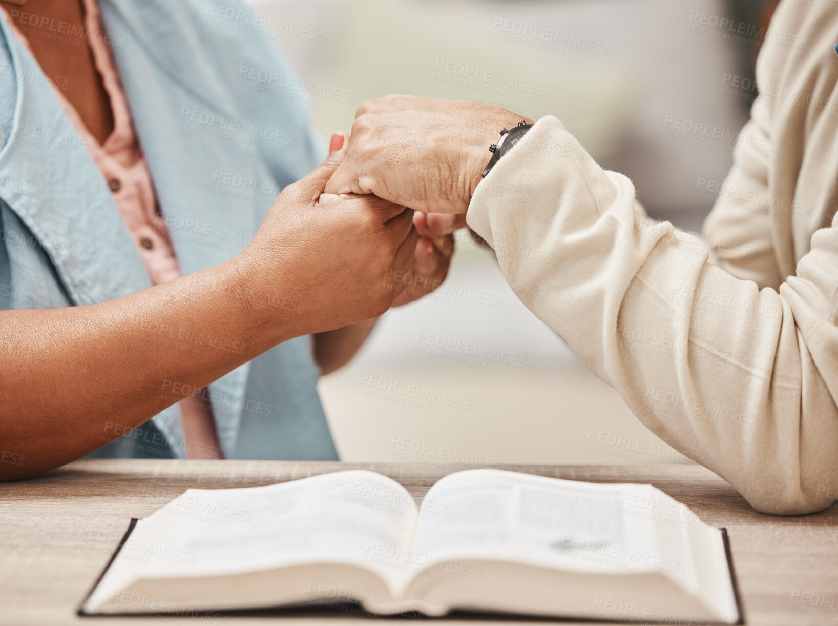 Buy stock photo Hands, bible and pray with a senior couple reading a book together in their home during retirement. Jesus, faith or belief with a man and woman praying to god in their house for spiritual bonding