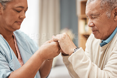 Bible, praying or old couple holding hands together in a Christian home in retirement with hope or faith. Jesus, religion or belief with a senior man and woman in prayer to god for spiritual bonding
