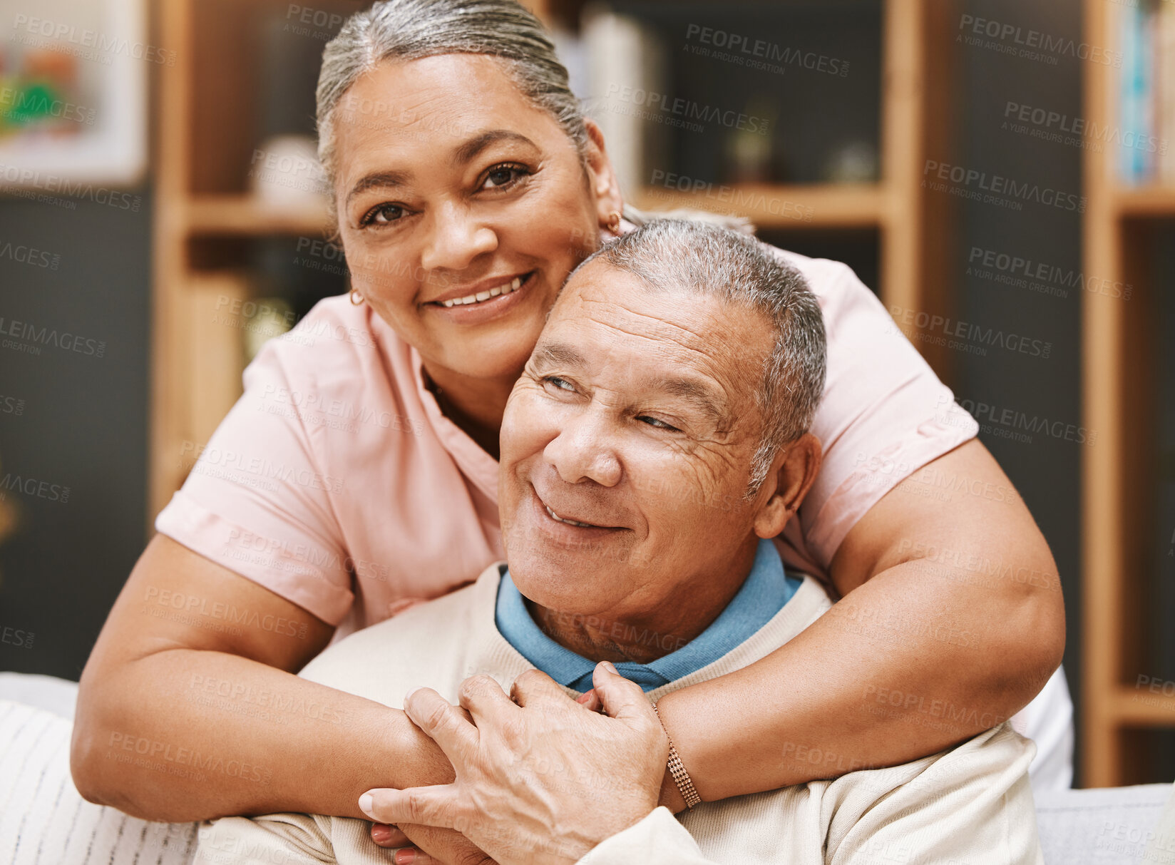 Buy stock photo Love, senior couple and hug in living room home, bonding caring and smiling. Valentines day, romance and portrait of man and woman hugging, embrace and cuddle for support while enjoying time together