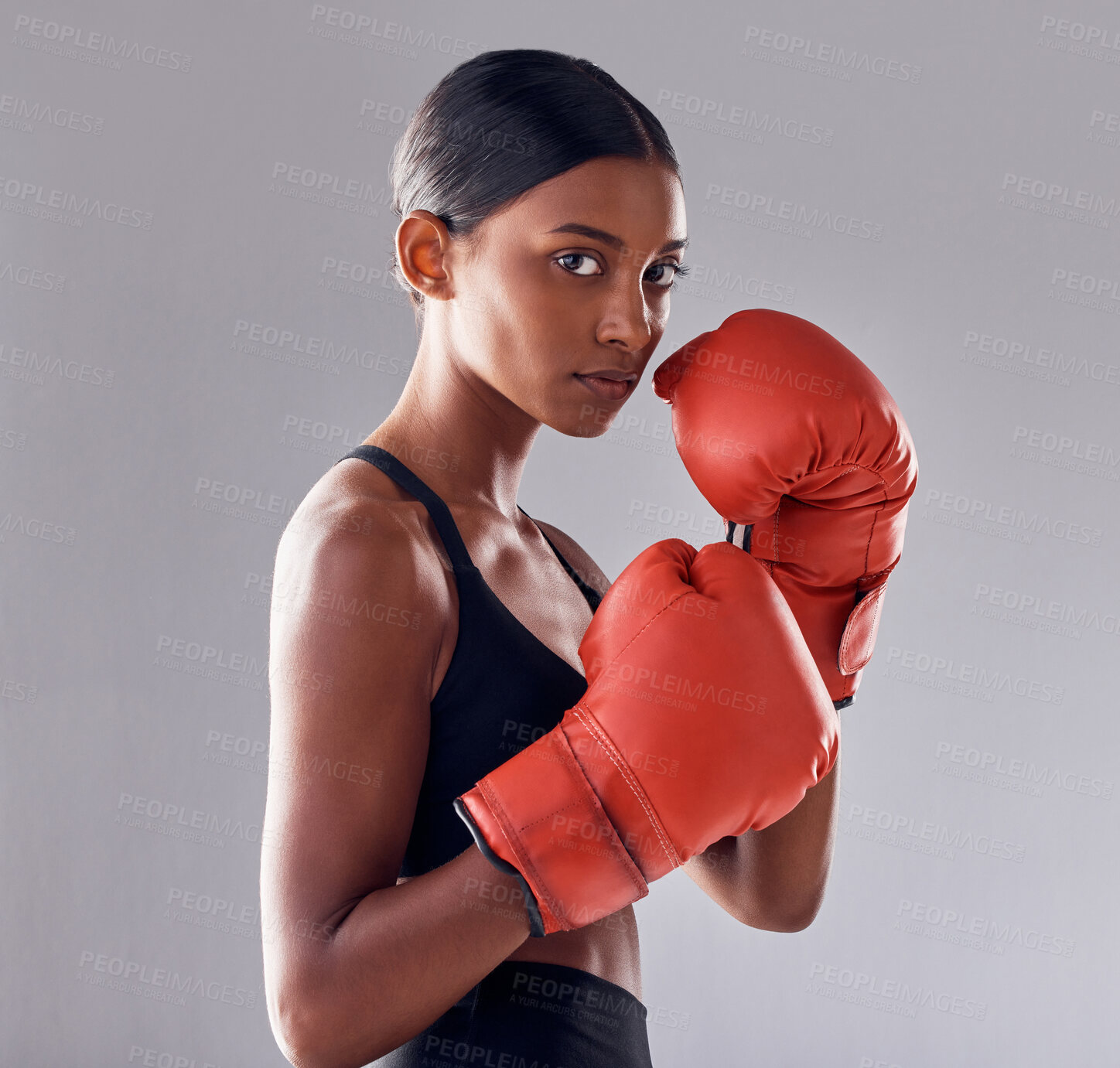 Buy stock photo Boxing, gloves and portrait of woman in studio for sports exercise, strong muscle or mma training. Indian female boxer, workout and fist fight for impact, energy and warrior power in battle challenge