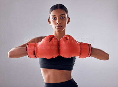 Buy stock photo Boxing, hand gloves and portrait of woman in studio for sports exercise, strong muscle or mma training. Indian female boxer, workout and fight for impact, energy and warrior power in battle challenge