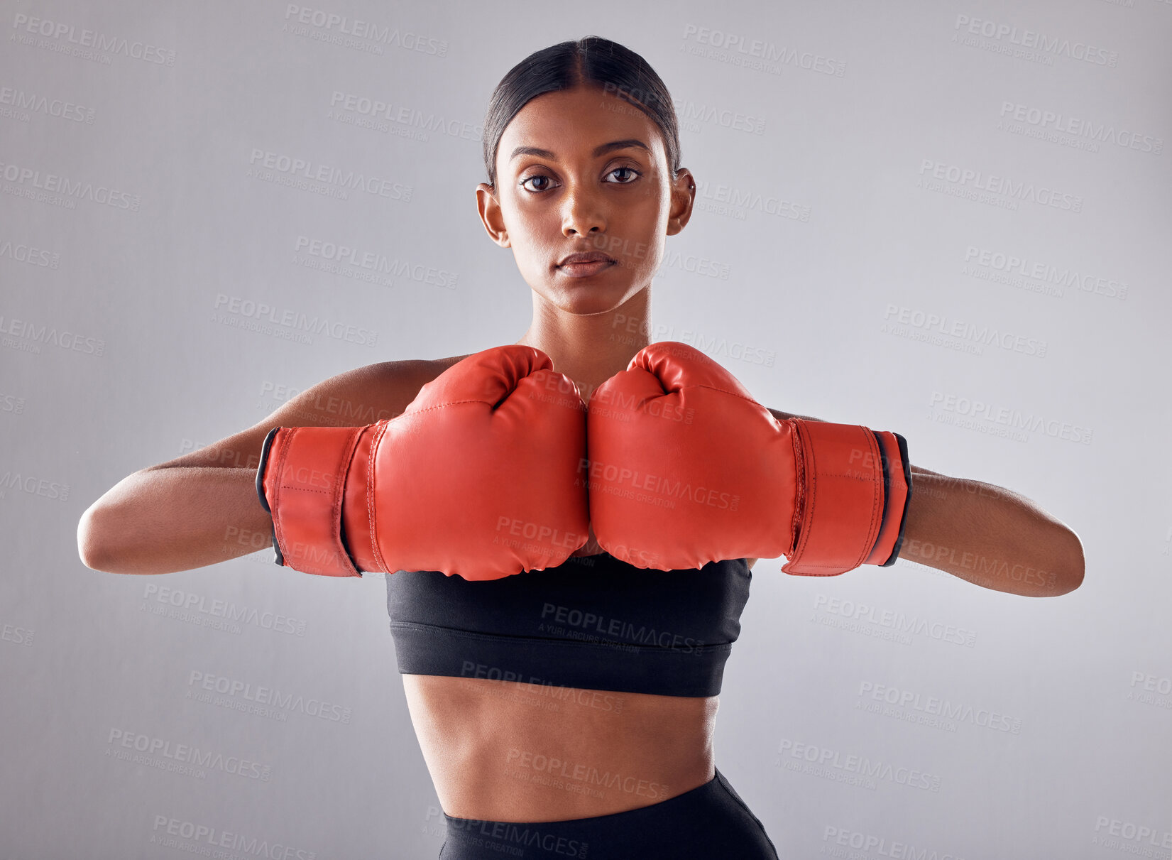 Buy stock photo Boxing, hand gloves and portrait of woman in studio for sports exercise, strong muscle or mma training. Indian female boxer, workout and fight for impact, energy and warrior power in battle challenge